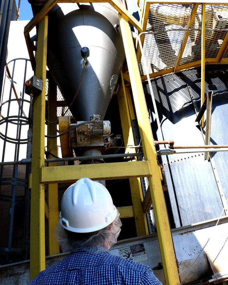 DHA expert observes dust collector.